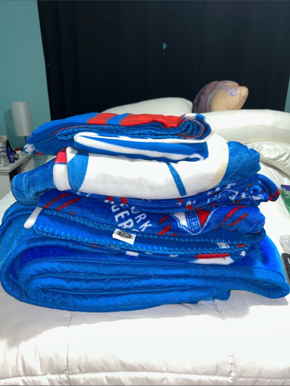 5 Assorted New York Ranger blankets.